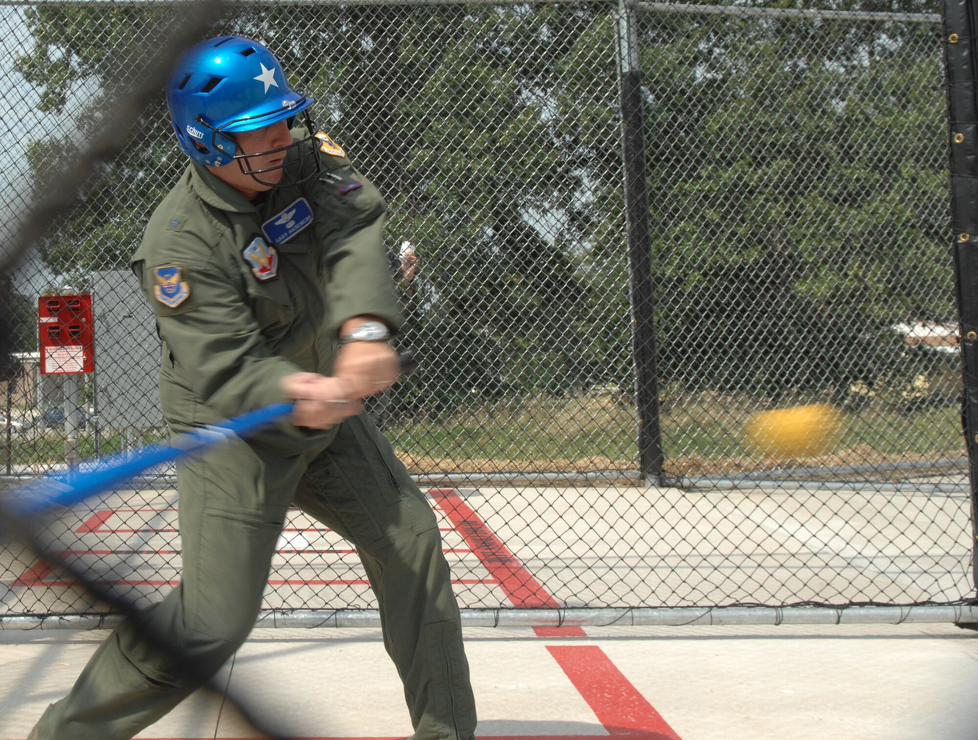 WHITEMAN AIR FORCE BASE, Mo. – Brig. Gen. Gary Harencak, 509th Bomb Wing commander, sends one flying at the batting cages grand opening Aug. 27. The batting cages are open from sun rise to sun down and are free of charge until January. The batting cages cost $145,000 and were largely paid for by recycling. (U.S. Air Force photo/Airman 1st Class Stephen Linch)