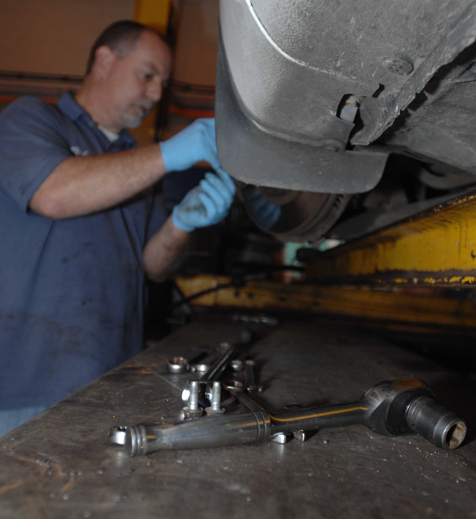 Nick Turmaime, an Auto Hobby Shop mechanic, performs an overall brake inspection Aug. 13, 2008. (U.S. Air Force photo by Airman First Class Brad Smith)