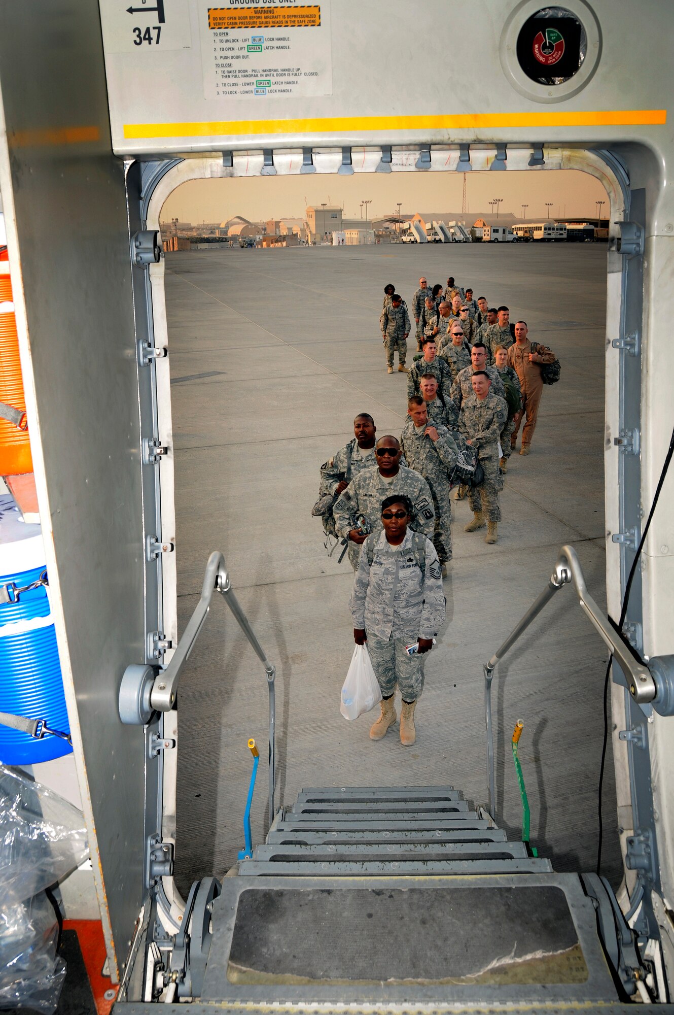Passengers line up to board a C-17 Globemaster III for transport to destinations within the U.S. Central Command’s area of responsibility Aug. 27, 2008, at an undisclosed air base in Southwest Asia.  The C-17 is the U.S. Air Force's premier airlifter and is responsible for transporting equipment, supplies and personnel throughout the theater of operations, supporting Operations Iraqi and Enduring Freedom and Joint Task Force-Horn of Africa.  (U.S. Air Force photo by Tech. Sgt. Michael Boquette/Released)
