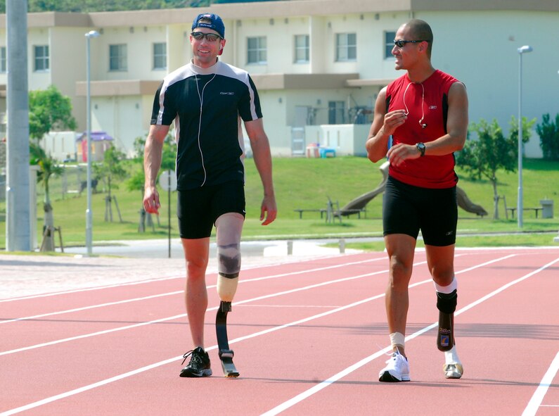 KADENA AIR BASE, Japan -- U.S. Paralympians Brian Frasure and Marlon Shirley talk about their training on the way back to the starting line during a training session Aug. 28. More than 100 athletes and support staff from the U.S. Paralympics track and field and swim teams arrived Aug. 24 to live and train for the next 10 days in preparation for the 2008 Paralympic Games held in Beijing, China Sept. 6. (U.S. Air Force photo/Airman 1st Class Amanda Grabiec)