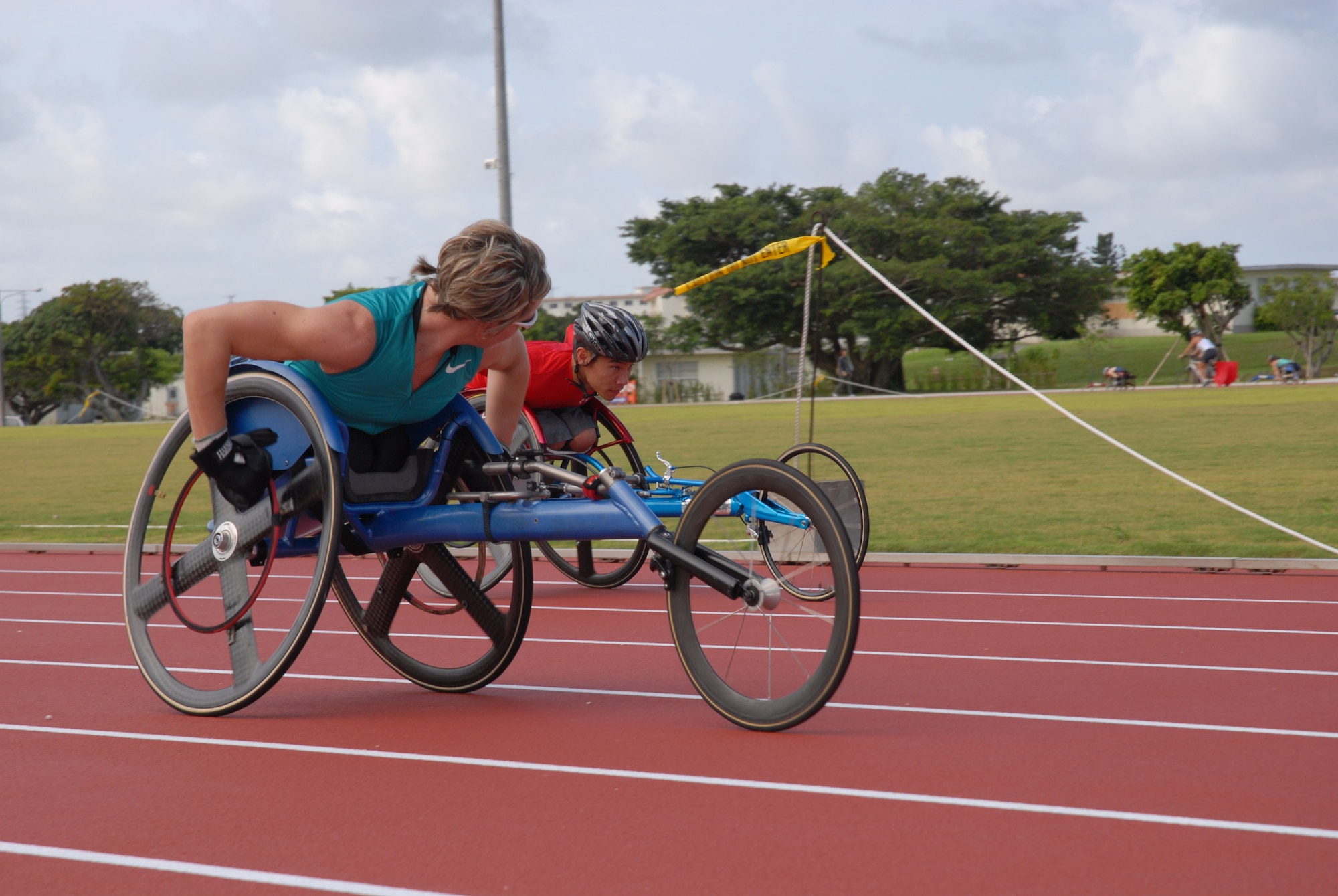 U.S. Paralympian Cheri Blauwet pushes teammate Tyler Byers during a training
session at the Ryukyu Middle school track at Kadena Air Base, Japan on Aug.
27. More than 100 athletes and support staff from the U.S. Paralympic
track and field and swim teams arrived at Kadena Aug. 24 to live and train
for the next ten days in preparation for the 2008 Paralympic Games held in
Beijing, China Sept. 6-17. (U.S. Air Force photo/Airman 1st Class Chad
Warren)