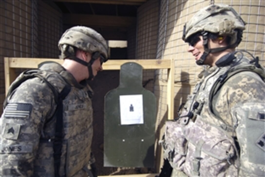 U.S. Army Sgt. Jayme Jones, left, and U.S. Army Staff Sgt. John Brennan have a laugh while they check out the target at a firing range on Forward Operating Base Hawk, Iraq, Aug. 22, 2008. The soldiers are assigned to Comanche Troop, 4th Squadron, 10th Cavalry, 4th Infantry Division.  
