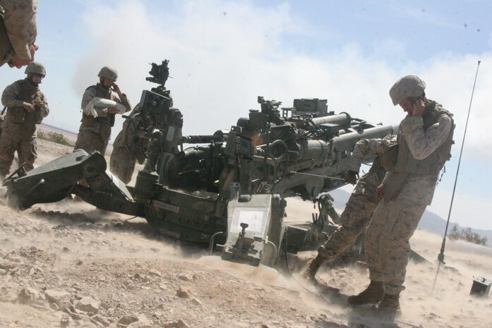 Cpl. Fernando Barajas, 22, a combat engineer with Route Clearance Platoon, Company A, 3rd Combat Engineer Battalion, Regimental Combat Team 5, carries a piece of ordnance Aug. 28 in the western Anbar province, Iraq.  The platoon conducted a cache sweep which yielded more than 530 ordnance rounds and more than 5,000 anti-aircraft and .50 cal rounds. The platoon traveled more than 40,000 yards on foot searching for possible cache sites Aug. 26-30.::r::::n::