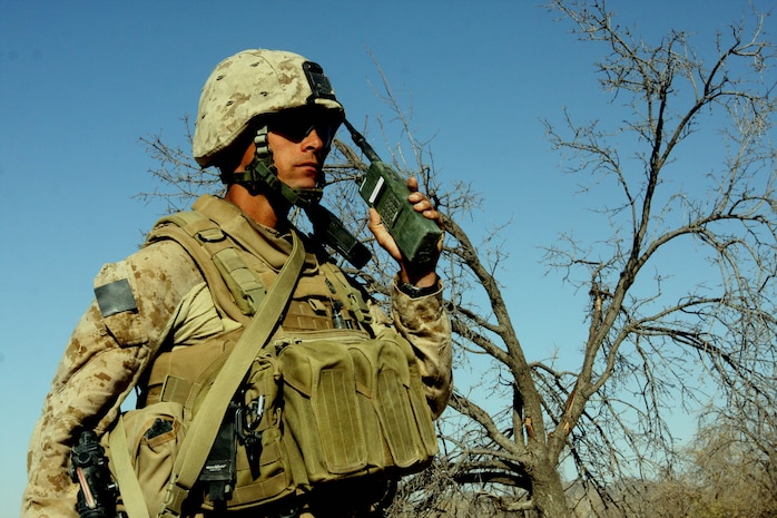 A Marine assigned to Combined Anti-Armor Team, Task Force 2nd Battalion, 7th Marine Regiment, 1st Marine Division, uses a handheld radio to keep in contact with the Marines assaulting a Taliban-held compound Aug. 28.