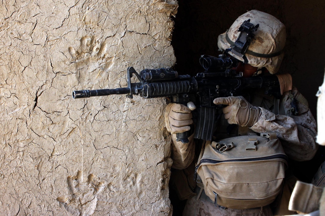 A Marine assigned to Company F, Task Force 2d Battalion, 7th Marine Regiment, 1st Marine Division, posts security for his platoon deep within a Taliban-held compound, Aug. 28. (U.S. Marine Corps photo by Cpl. James M. Mercure)