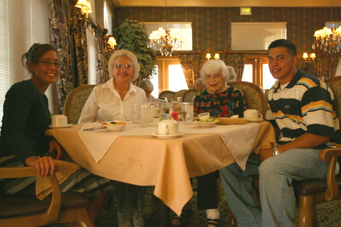 Lance Cpl. Rachel Panganiban and Cpl. Nelson Lovos,  both from Combat Logistics Regiment 17, shared conversation and dinner with Jen Tolliver (L) and Mitzi Bisson. The Marines headed out to the Fairview - Ivy Ranch retirement community as part of community involvement with the Single Marine Program Aug. 28.