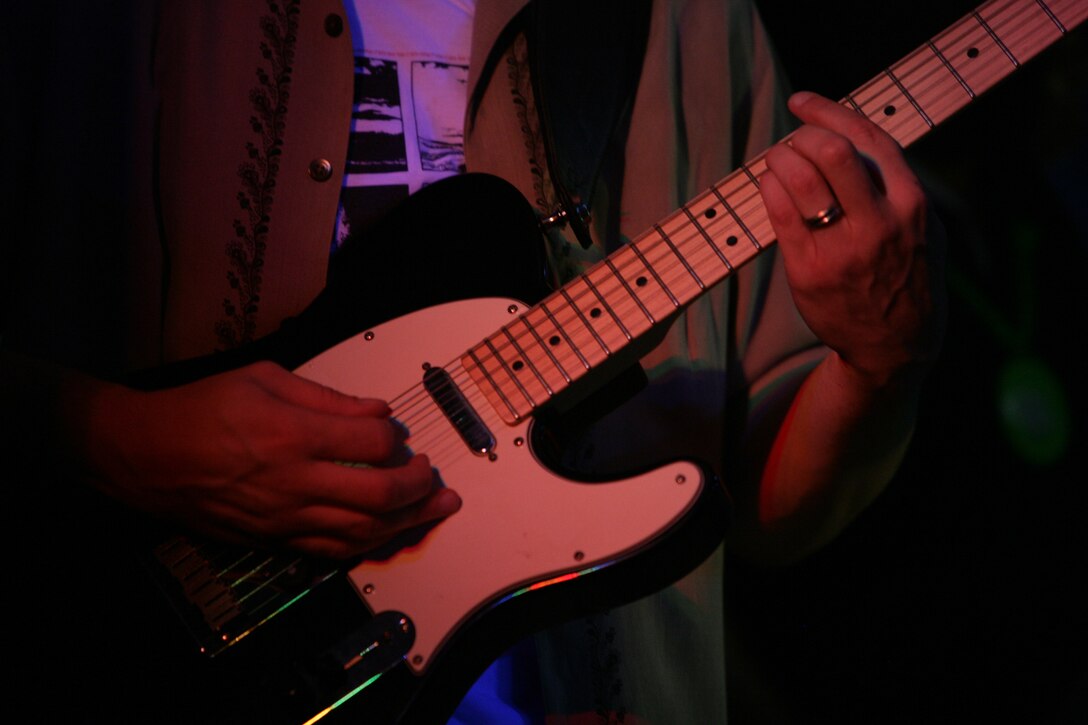 Sgt. Lee Sutton, a guitarist with Deep 6, performs with the band live for the first time Aug. 29.  The members of the band are all somehow related to the Marine Corps and got together in August through mutual friends just to have some fun.