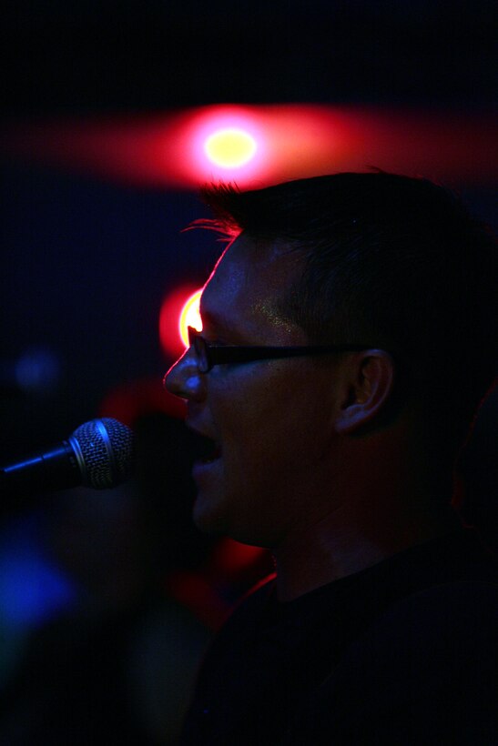 Dan Claire, a guitarist and vocalist with Deep 6, sings during the first live performance of the recently created band, consisting of eight Marines and civilians, at a local bowling alley Aug. 29.  The members of the band are all somehow related to the Marine Corps and got together in August through mutual friends just to have some fun.