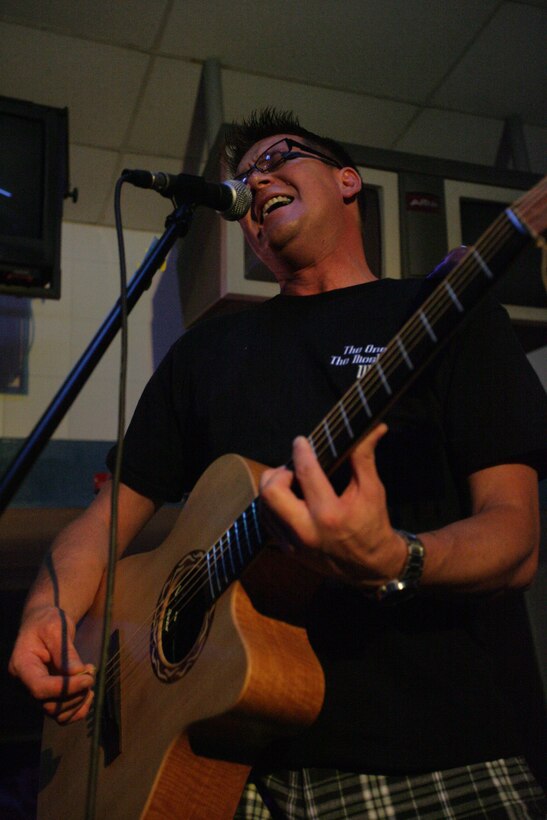 Dan Claire, a guitarist and vocalist with Deep 6, performs an acoustic solo of Sublime’s “Boss D.J.,” during the bands first live performance at a local bowling alley Aug. 29.  The members of the band are all somehow related to the Marine Corps and got together in August through mutual friends just to have some fun.