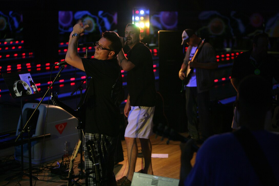 Members of Deep 6, a recently created band consisting of eight Marines and civilians, perform for the first time to a live audience at a local bowling alley Aug. 29.  The members of the band are all somehow related to the Marine Corps and got together in August through mutual friends just to have some fun.