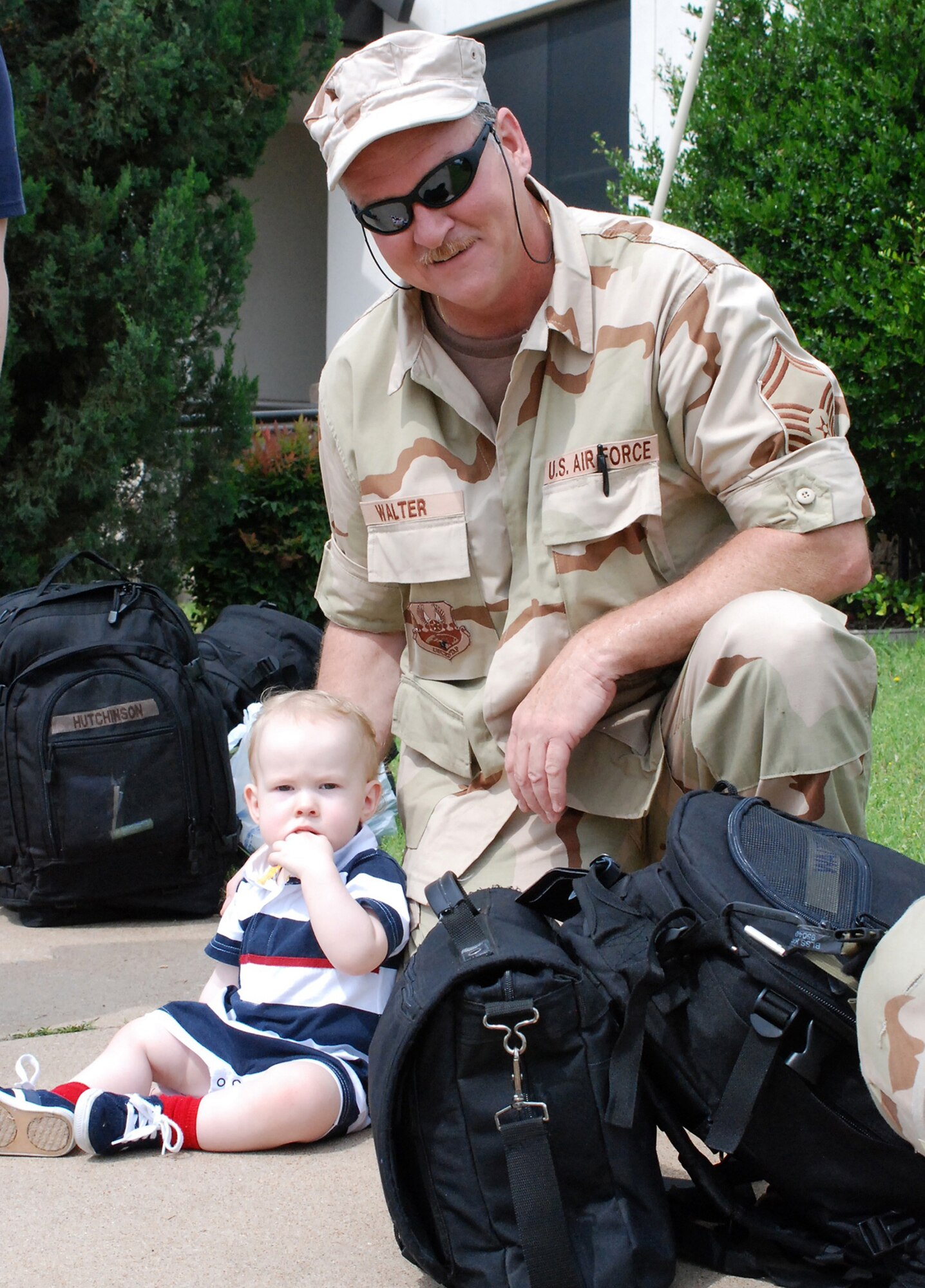 Senior Master Sgt. Dennis Walter spends some time with his grandson before his deploymnet to Iraq. (U.S. Air Force Photo/Tech. Sgt. Julie Briden-Garcia)