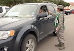 Senior Airman Pauline Flores, Air Force Personnel Center, hands a "Thank You For Wearing Your Seatbelt" card to a person leaving for lunch Aug. 29 at the AFPC complex. Officials stressed safety for the Labor Day weekend by handing out thank you cards and coupons to the base exchange to personnel who were buckled up. (U.S. Air Force photo by Staff Sgt. Tim Bazar)