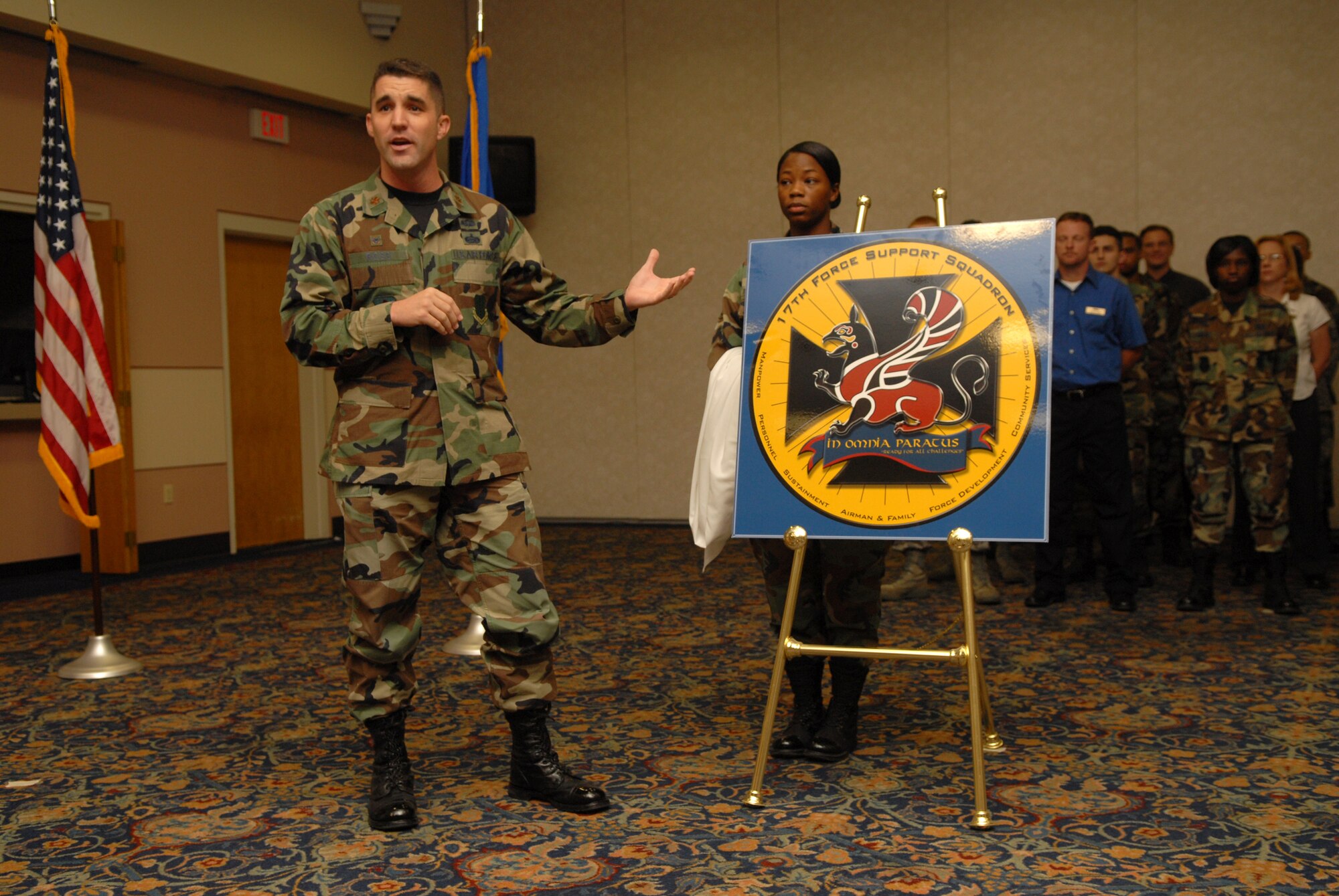 Major Clinton Ross unveils the 17th Force Support Squadron crest during the 17 FSS stand-up ceremony Aug. 22. Personnel from the former 17th Mission Support Squadron and 17th Services division merged to create the new squadron. (U.S. Air Force photo by Senior Airman Kasabyan Musal)