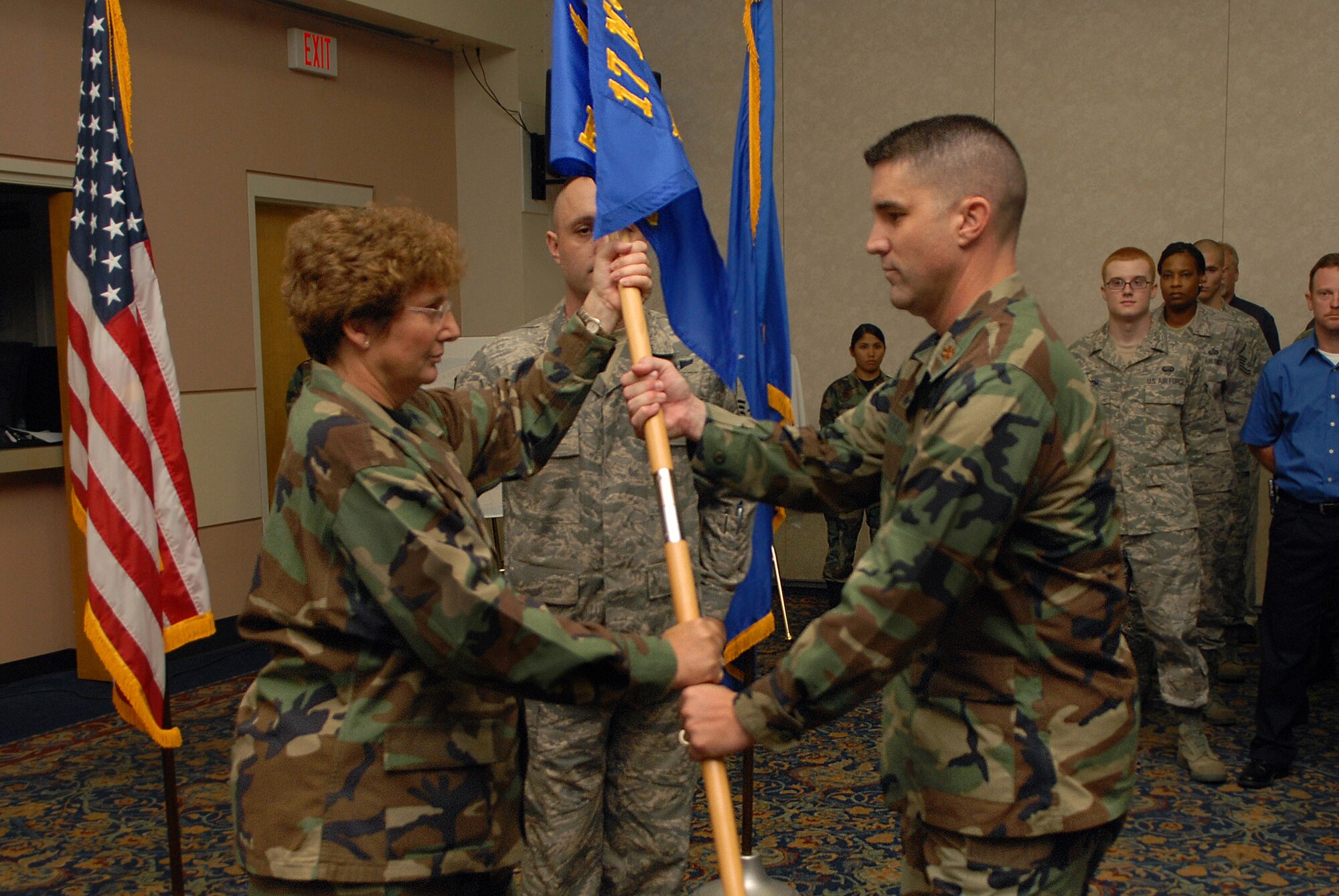 Major Clinton Ross accepts command of the 17th Force Support Squadron from Col. Ada Conlan, 17th Mission Support Group commander, during the 17 FSS stand-up ceremony Aug. 22. Personnel from the former 17th Mission Support Squadron and 17th Services division merged to create the new squadron. (U.S. Air Force photo by Senior Airman Kasabyan Musal)