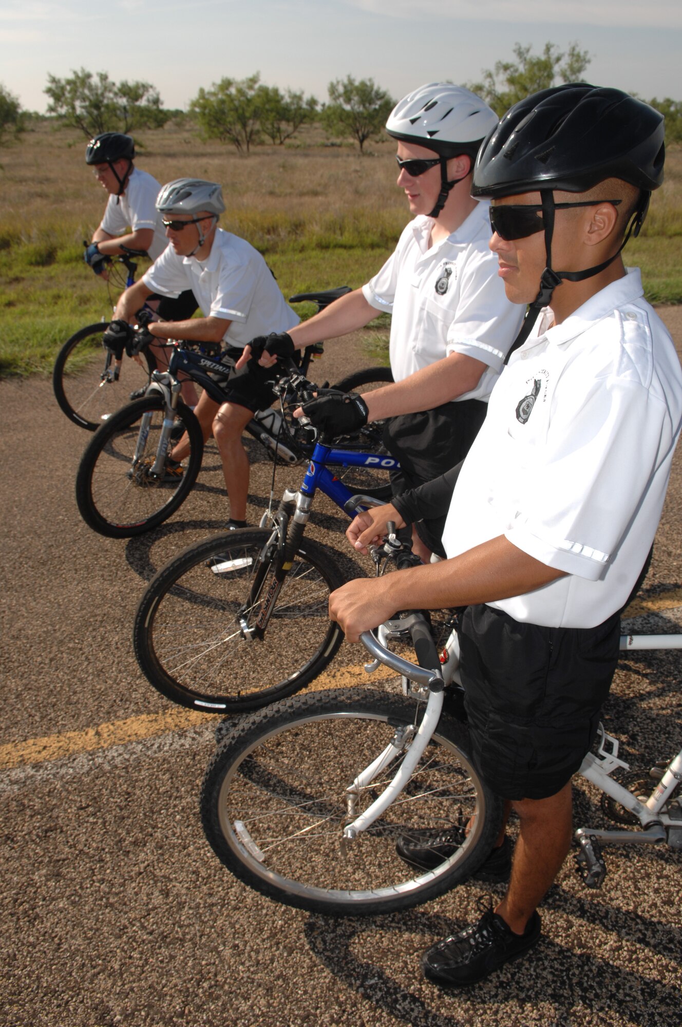 17th Security Forces Squadron members navigate an obstacle course during a basic bicycle skills training course Aug. 22 on Goodfellow. Members of the 17 SFS took the course to augment Goodfellow’s security patrols with bikes. (U.S. Air Force photo by Staff Sgt. John Barton)