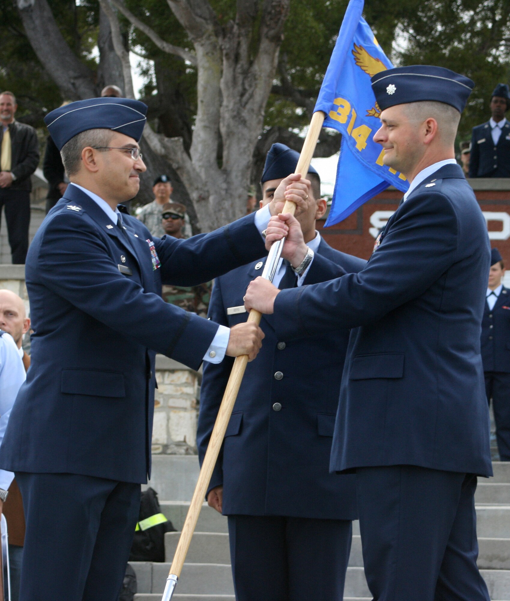 Colonel Anthony Lombardo, 17th Training Group commander, passes the 314th Training Squadron guidon to Lt. Col. Jonathan Rice IV during the squadron stand-up ceremony Aug. 5. (U.S. Air Force photo)