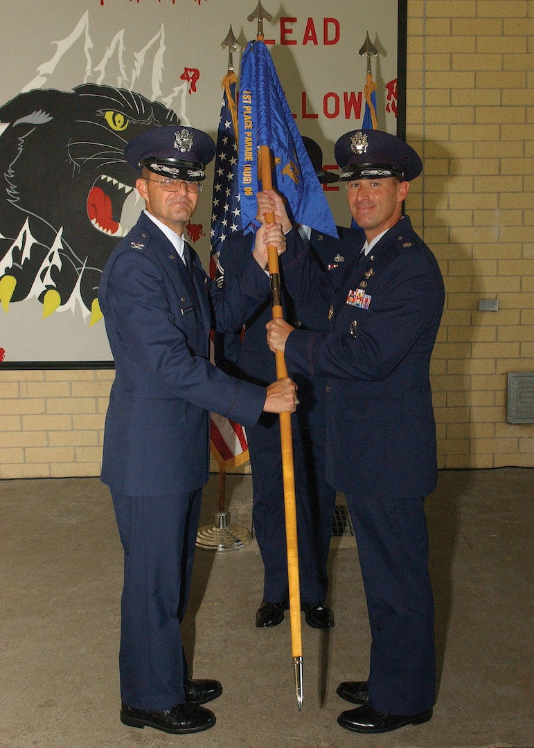 8/25/2008 - Lt. Col. Douglas McCobb accepts the 321st Training Squadron flag from Col. Edward Westermann, 737th Training Group commander, during a re-activation ceremony Aug. 25. (USAF photo by Alan Boedeker) 