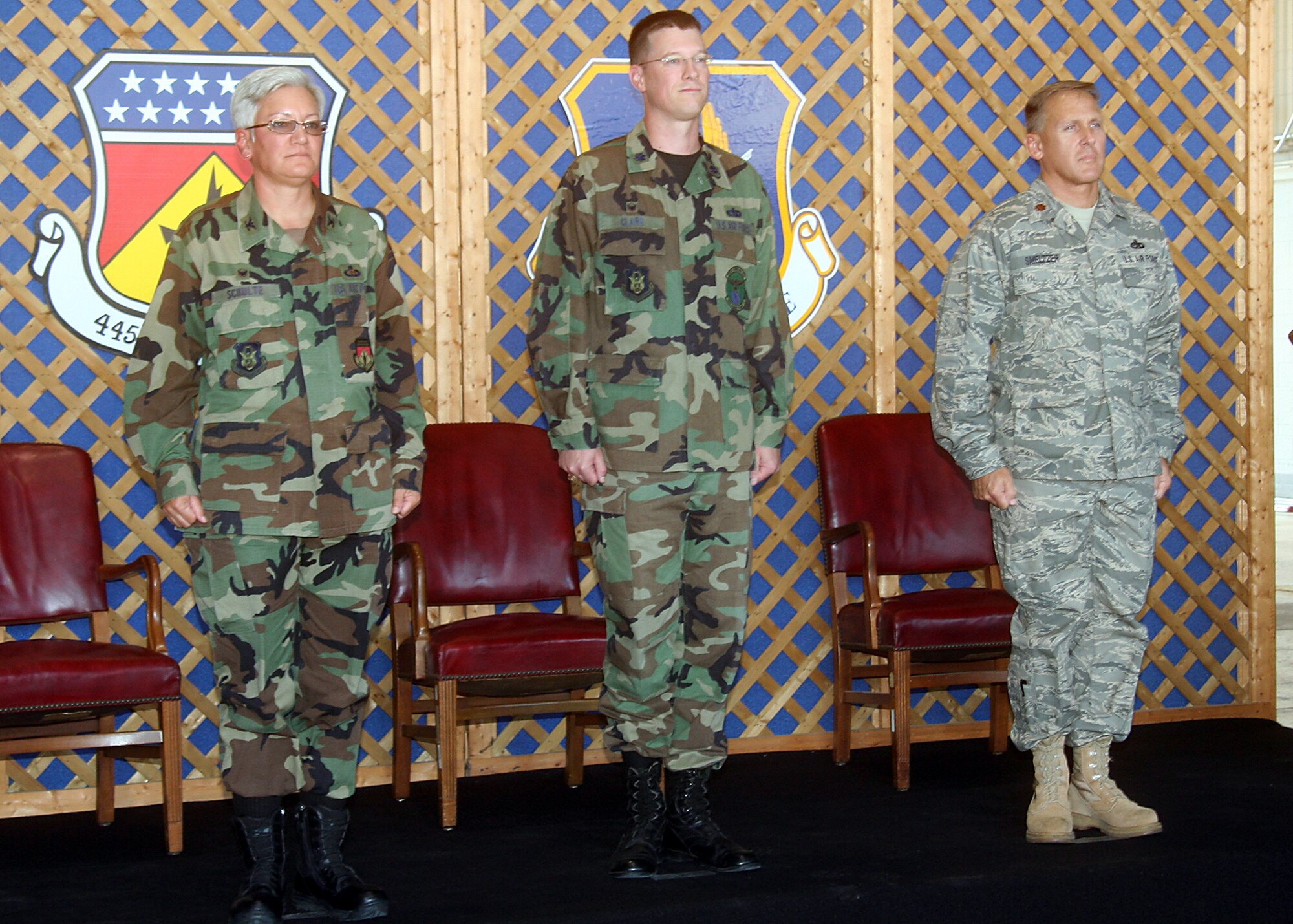 During a Change of Command Ceremony on August 3, 2008, Lt. Col. Michael E. Clark (center) relinquished command of the 445th Maintenance Squadron to Maj. Jay M. Smeltzer (right). Col. Anna M. Schulte (left), Commander of the 445th Maintenance Group, presided over the ceremony and will welcome Colonel Clark as he moves up and accepts the responsibilities of being the deputy commander for the 445th Maintenance Group. "It's been a great ride," said Colonel Clark as he addressed his squadron for the last time. "The lessons you have taught me along the way I will use not just as a reservist, but also in my life, he added. As Major Smeltzer assumed command he offered these words to his new squadron. "Everything we do here counts. When these planes leave here, other Airmen are depending on them. Don't ever forget that."  (U.S. Air Force photo by Senior Airman Ken LaRock)