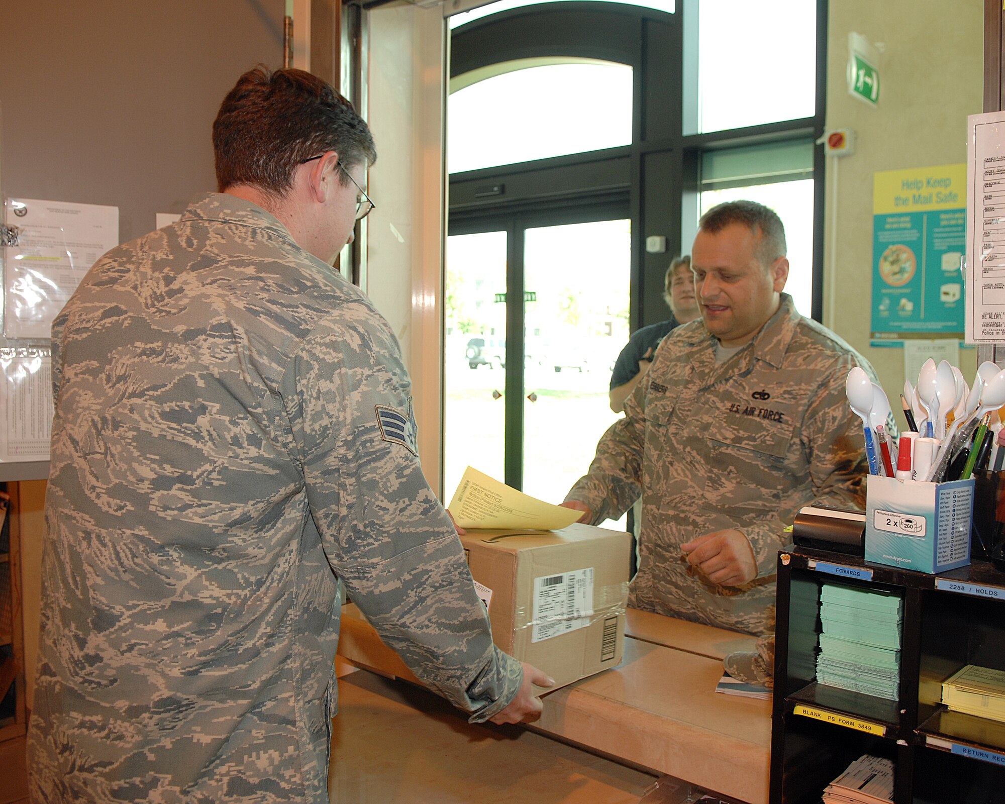 Tech. Sgt.  Kenneth Ebbers picks up a package at the  AVIANO AIR BASE, Italy post office. The post office will be closed for training on the first and third Wednesday of every month. (U.S. Air Force photo/Senior Airman Senior Airman Taylor Marr)