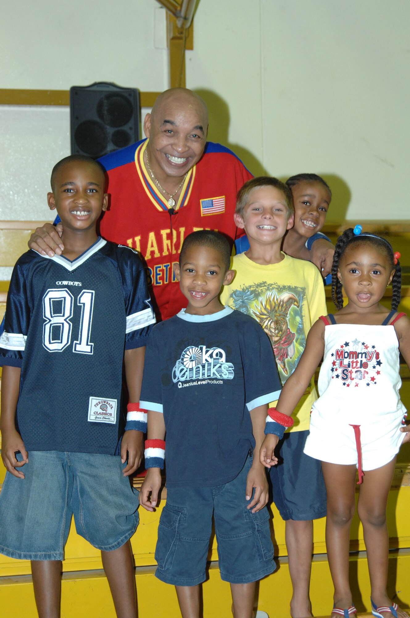 Curly Neal poses with some of Incirlik’s youth at the Incirlik Fitness Center, Aug. 23. All the children received Harlem Globe Trotter wrist bands from Curly after his performance.