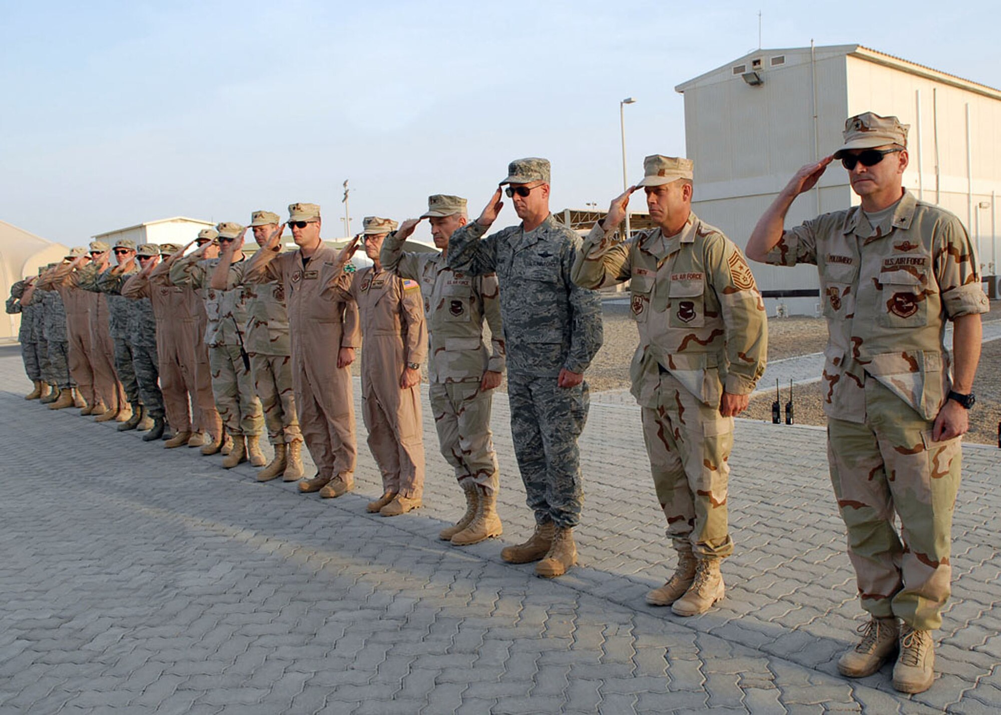 SOUTHWEST ASIA -- The 380th Air Expeditionary Wing's newest Command Chief, Chief Master Sgt. Martin Smith (second from right), stands next to 380th AEW Commander, General H.D. Polumbo, Jr., (far right), during retreat here Aug. 22. (U.S. Air Force photo by Airman 1st Class Alexandra Sandoval)(released)