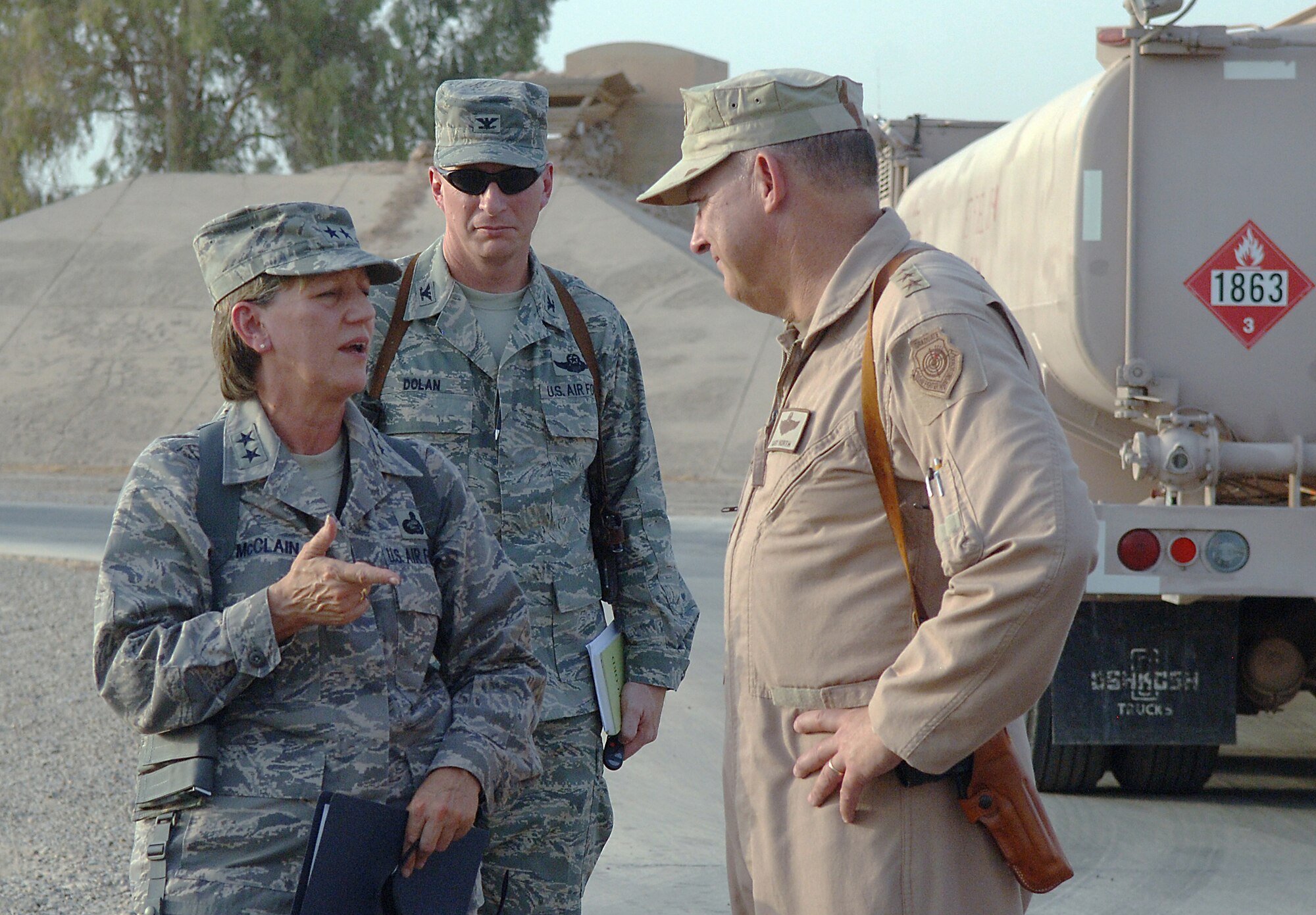 JOINT BASE BALAD, Iraq -- Maj. Gen. K. C. McClain (left) speaks with Lt. Gen. Gary North (right) about their tour of the 332nd Expeditionary Logistics Readiness Squadron's Petroleum, Oil and Lubricants Management Flight here Aug. 27. McClain accompanied North on a tour of several locations here and throughout the U.S. Central Command area of responsibility. This is McClain's first visit to the Middle East since assuming command of the Air Force Personnel Center in January. North is the commander of U.S. Air Forces Central and the Combined Forces Air Component Commander. Also pictured is Col. John Dolan, 332nd Air Expeditionary Wing vice commander. (U.S. Air Force photo/Tech. Sgt. Richard Lisum)