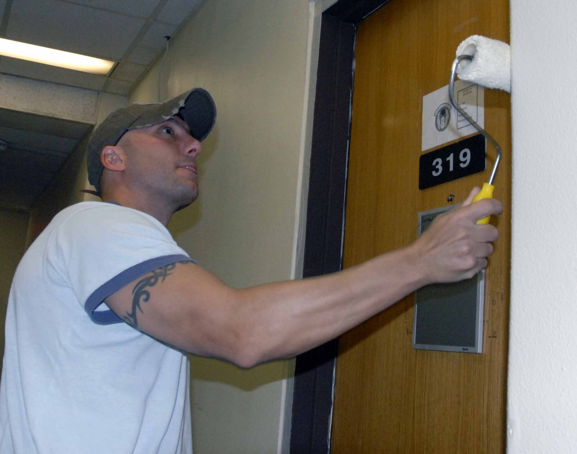 OSAN AIR BASE, Republic of Korea -- 1st Lt. Dave Embrey, 51st Security Forces Squadron, paints a wall in Dorm 1436. Dorm residents, supervisors, first sergeants, squadron and wing leadership spent Aug. 23 cleaning up and repainting the dormitory. The project is part of a long renovation process initiated by Dorm 1436 residents to instill a sense of ownership in their home. (U.S. Air Force photo/Staff Sgt. Candy Knight)