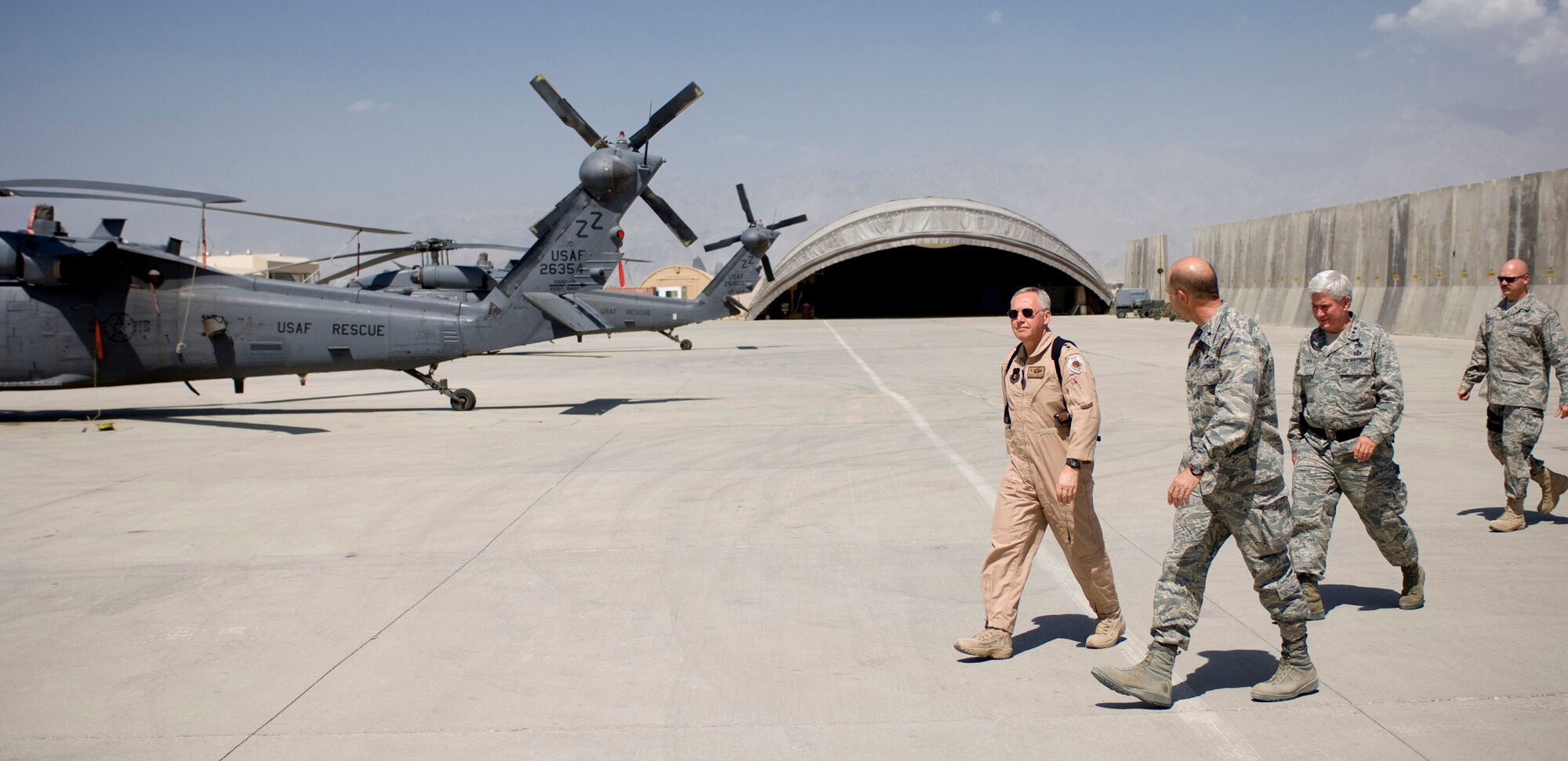 BAGRAM AIR FIELD, Afghanistan -- General Bruce Carlson, Air Force Materiel Command commander, tours the HH-60G Pave Hawks with Brig. Gen. Mike Holmes, 455 Air Expeditionary Wing commander, here on August 22, 2008. General Carlson stopped at Bagram Air Field during his final trip to Southwest Asia before retiring. (U.S. Air Force photo by Staff Sgt. Samuel Morse/Released)