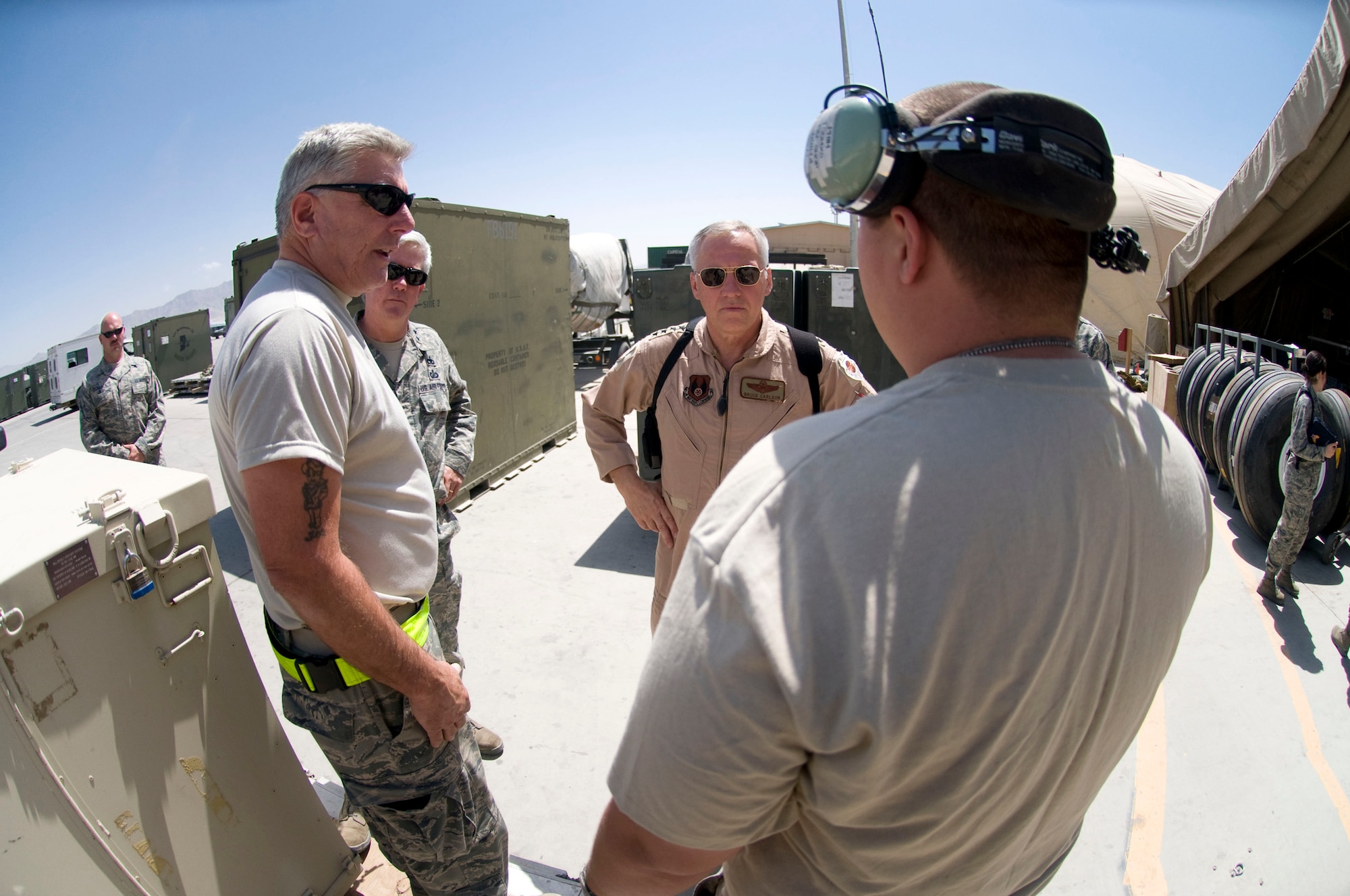 BAGRAM AIR FIELD, Afghanistan -- General Bruce Carlson, Air Force Materiel Command commander, visits with Air National Guardsmen Tech. Sgt. Joseph McElroy (left) and Senior Airman Jonathan Prim (right), here on August 22, 2208. Sergeant McElroy is an electrical/environmental craftsman deployed from the 143rd Airlift Wing, Quonset-Holland Air National Guard Base, RI., and Airman Prim is deployed from the 135th Maintenance Squadron, Martin State Airport, Md. (U.S. Air Force photo by Staff Sgt. Samuel Morse/Released)