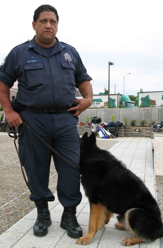 Pentagon Force Protection Agency Sgt. Isaac Hoopii poses with his present-day canine assistant, Marko, at the Pentagon Memorial, Aug. 28, 2008. During 9/11, Hoopii assisted injured people and pulled security sweeps at the stricken Pentagon with his German shepherd bomb-detection dog, Vito, who since has retired from duty. Defense Dept. photo by Gerry J. Gilmore