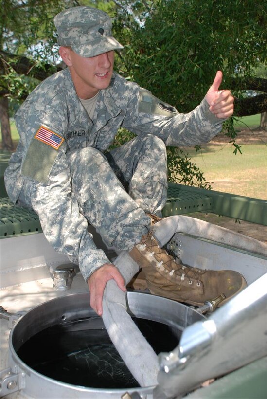U.S. Army Spc. Joseph P. Gauthier of Natchitoches, La.,  gives the thumbs up to soldiers working to fill a palletized load system water hippo, Aug. 28, 2008. He serves with Detachment 1, Company A, 199th Leadership Brigade Support Battalion, 256th Infantry Brigade Combat Team in Colfax, La.
