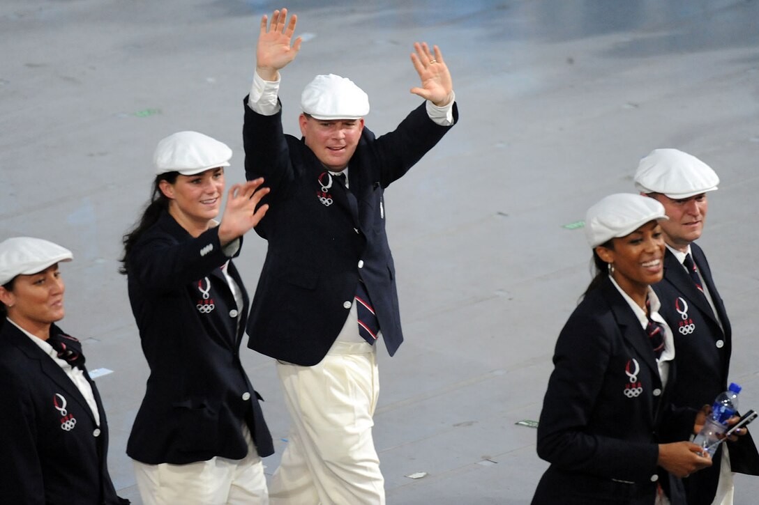 U.S. Army World Class Athlete Program marksman Maj. Michael Anti raises his hands for the crowd as Team USA marches around the Bird's Nest National Stadium during the Opening Ceremony of the Summer Olympic Games Aug. 8 in Beijing. Anti, a 2004 Olympic silver medalist in three-position rifle shooting, will compete in his fifth Olympics in the 50-meter prone rifle event on Aug. 15. WCAP rifle coach Maj. David Johnson, far right, also is among the group. 