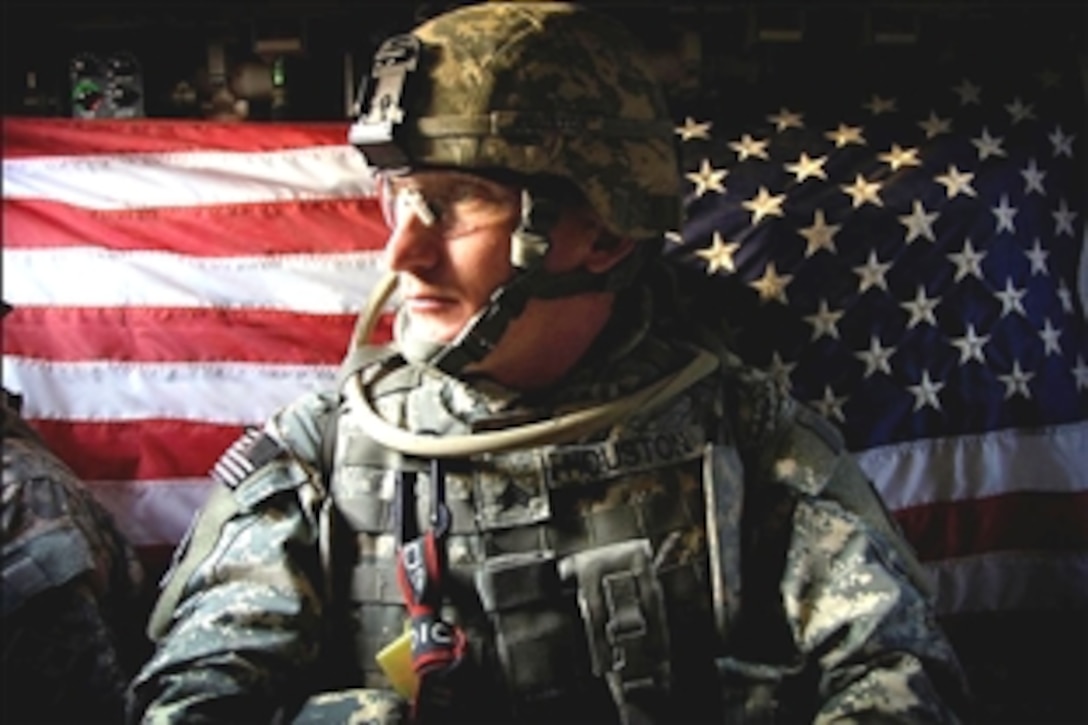 U.S. Army Sgt. Whitney Houston sits in a Stryker armored vehicle decorated with a hint of patriotism, en route to a controlled fire mission, in Tarmiyah, Iraq, Aug. 26, 2008. Houston is assigned to the Public Affairs Office, 25th Infantry Division. 
    
