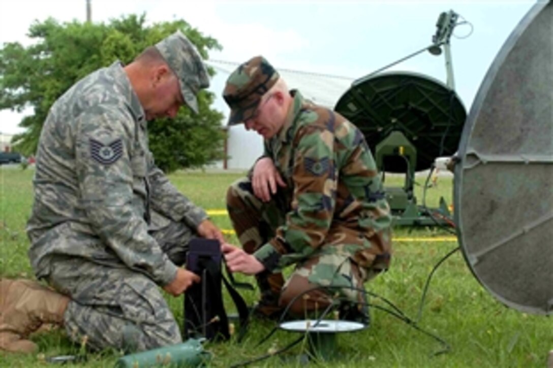 U.S. Air Force Tech. Sgt. Bill Smith, left, practices aligning a satellite with the help of Staff Sgt. Scott Roach, Aug. 29, 2008. The men are members of the Arkansas Air Guard's 154th Weather Flight, which provides weather support to the Arkansas Army Guard's 1st Battalion, 114th Security and Support in the event of a call from the Gulf Coast states in the event of a natural disaster. 