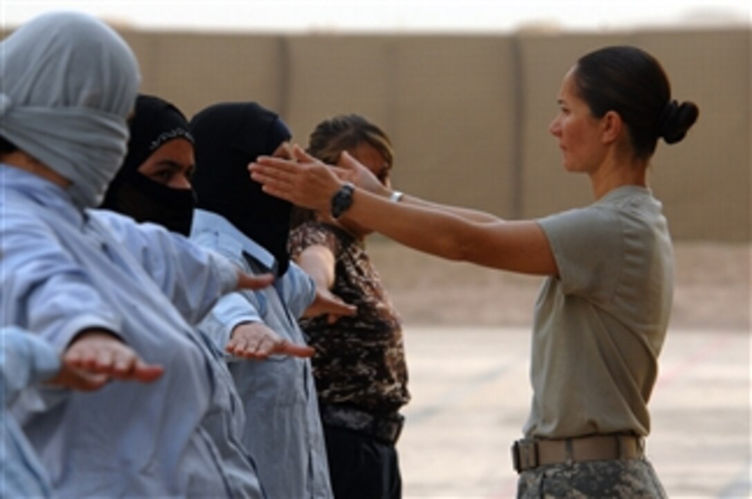 U.S. Army Sgt. 1st Class Sumalee Bustamante forms up the female class of trainees for physical training at the Kirkuk Iraqi Police Academy, Iraq, on Aug. 26, 2008.  Bustamante is a Platoon Sergeant with Brigade Special Troops Battalion, 10th Mountain Division, deployed to Forward Operating Base Warrior, Iraq.  