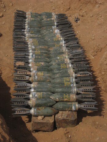 After being discovered, 90mm mortars lie on top of an assortment of anti-aircraft and .50 cal rounds, which were found by Route Clearance Platoon, Company A, 3rd Combat Engineer Battalion, Regimental Combat Team 5, during a cache sweep Aug. 26-30 in western Anbar province, Iraq. The platoon found more than 530 pieces of ordnance and 5,000 anti-aircraft and .50 cal rounds during the cache sweep. ::r::::n::