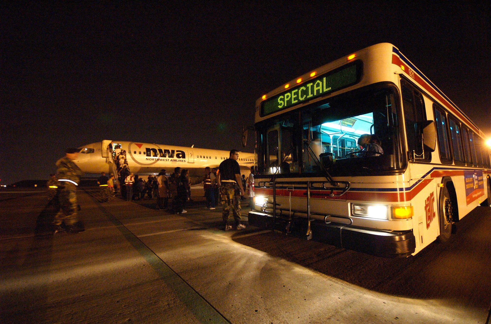 A group of displaced persons from New Orleans board a bus the Kentucky Air National Guard Base in Louiville for transportation to a Red Cross Shelter on Aug. 30. The 178 evacuees arrived at the Kentucky Air Guard Base aboard a commercial airliner at 9:20 p.m. Eastern Time.