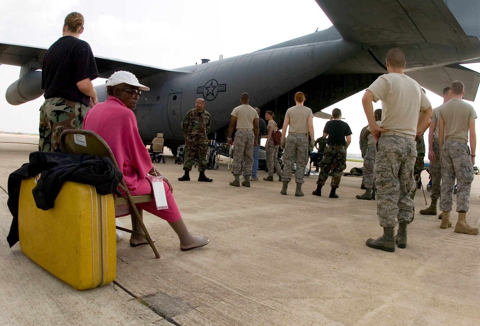 Frances Boudoin sits on a chair on the flight line at the former Kelly Air Force Base, Texas, Aug. 30 as she awaits transportation to a shelter. The Texas Air National Guard C-130 brought 23 evacuees from Beaumont, Texas, to San Antonio before Hurricane Gustav reached the Gulf Coast.  Members from the 37th Training Wing and 59th Medical Wing at Lackland AFB, Texas, and from the Air National Guard and Air Force Reserve help in the hurricane relief efforts as Hurricane Gustav approaches the Gulf Coast. The Port of San Antonio on Kelly AFB is the staging base for FEMA Region 6.  (U.S. Air Force photo/Staff Sgt. Desiree N. Palacios)