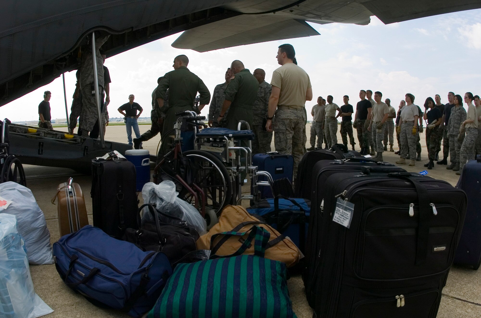 Luggage is unloaded from a Texas Air National Guard C-130 Hercules carrying 23 evacuees from Beaumont, Texas, Aug. 30 to the former Kelly Air Force Base, Texas.  Members from the 37th Training Wing and 59th Medical Wing at Lackland AFB, Texas, and from the Air National Guard and Air Force Reserve help in the hurricane relief efforts as Hurricane Gustav approaches the Gulf Coast. The Port of San Antonio on Kelly AFB is the staging base for FEMA Region 6.  (U.S. Air Force photo/Saff Sgt. Desiree N. Palacios)