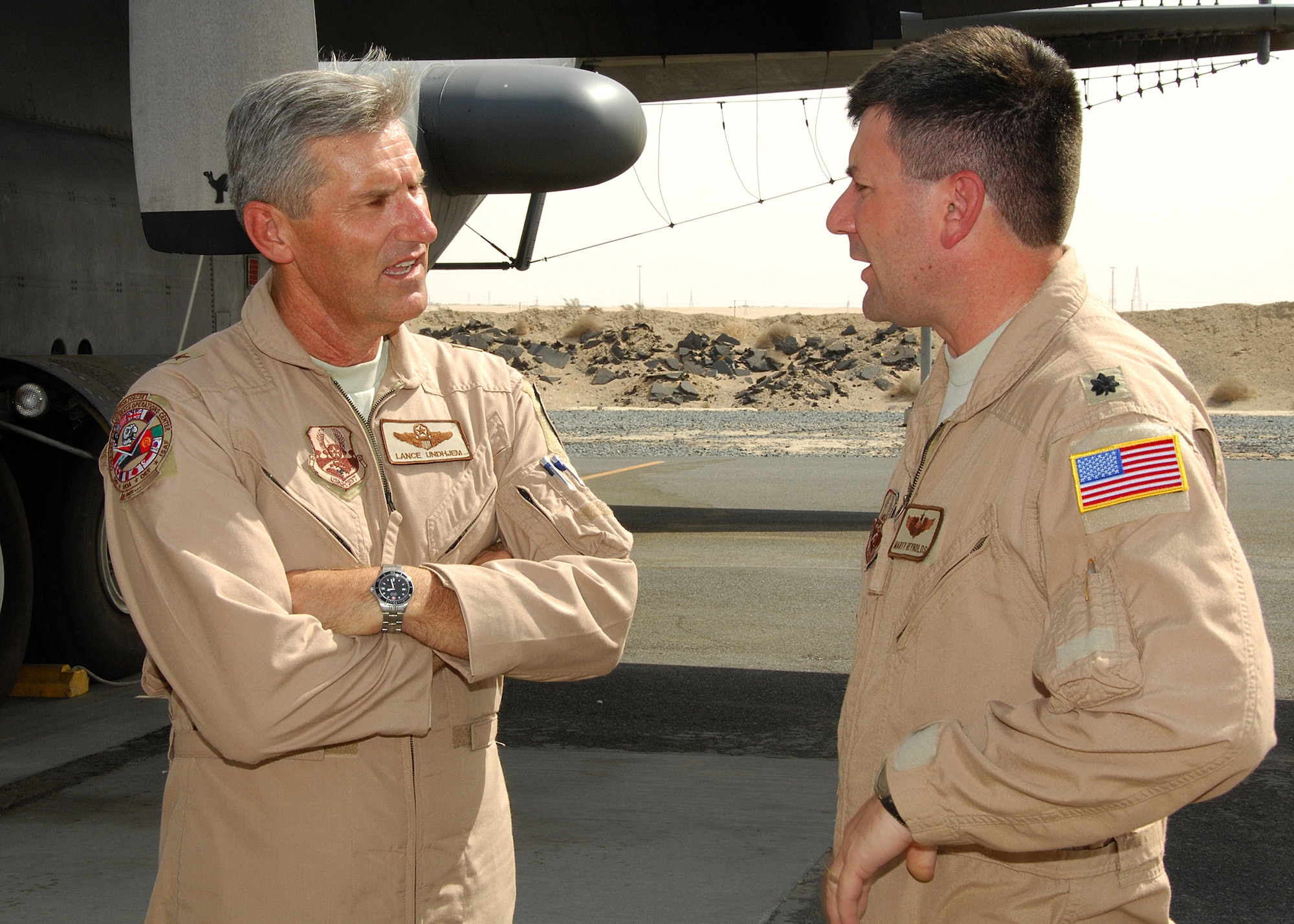 SOUTHWEST ASIA -- Brig. Gen. Lance Undjem, Combined Air and Space Operations Center director, talks with Lt. Col. Marty Reynolds, 43rd Expeditionary Electronic Combat Squadron, about the capabilities of the EC-130H Compass Call on Aug. 29 at an air base in Southwest Asia. General Undjem is the new CAOC director, and is touring U.S. Central Command observing how the CAOC contributes to day-to-day operations in the theater. Colonel Reynolds is deployed from Davis-Monthan Air Force Base, Ariz. (U.S. Air Force photo/Tech. Sgt. Raheem Moore)