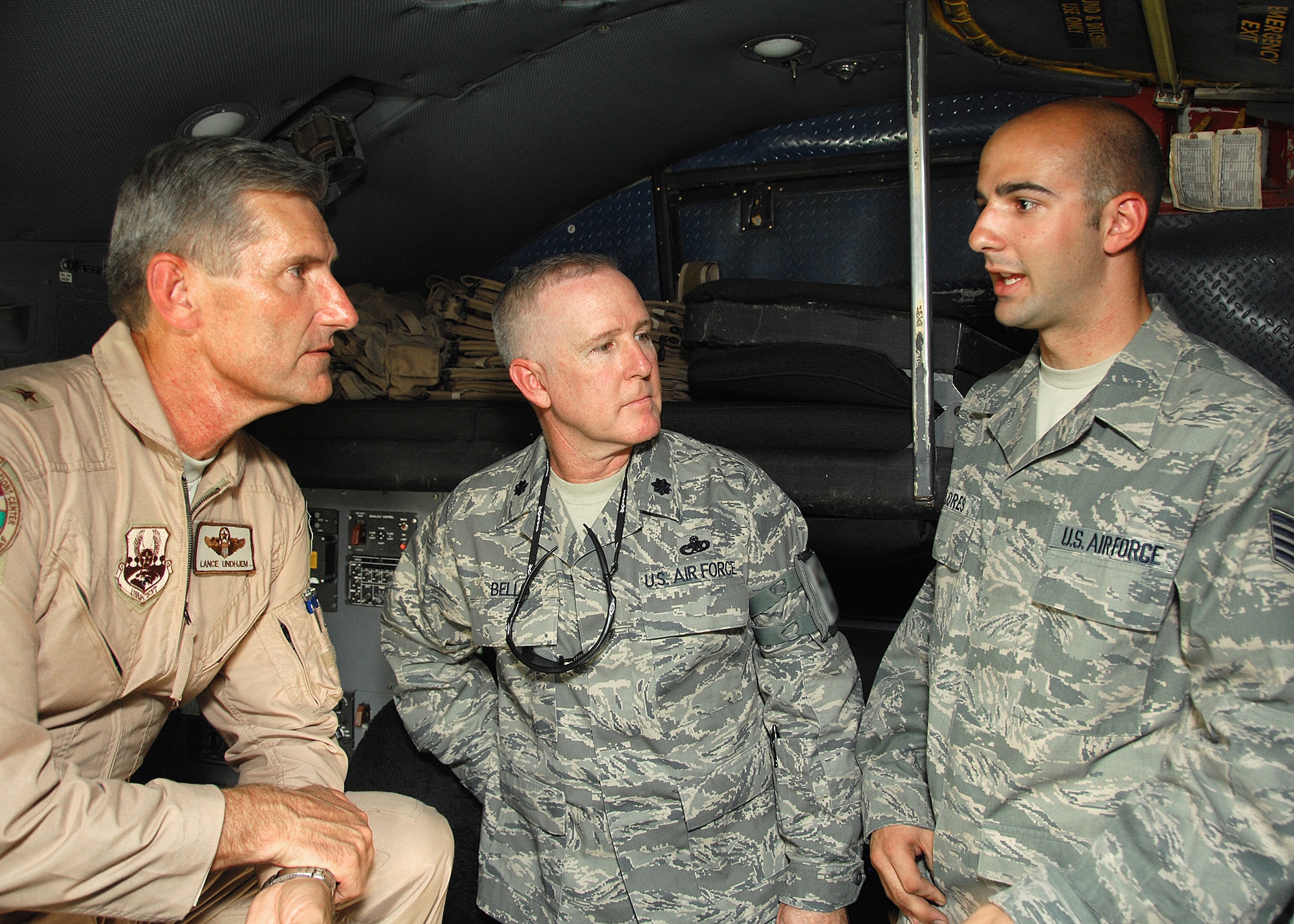 SOUTHWEST ASIA -- Brig. Gen. Lance Undjem, Combined Air and Space Operations Center director, talks with Lt. Col. Alfred Bello and Staff Sgt. Ryan Flores, both with the 386th Expeditionary Aircraft Maintenance Squadron, about how the CAOC can help improve maintenance processes on the C-130 on Aug. 29 at an air base in Southwest Asia. General Undjem is the new CAOC director, and is touring U.S. Central Command observing how the CAOC contributes to day-to-day operations in the theater. Sergeant Flores is deployed from Dyess Air Force Base, Texas. (U.S. Air Force photo/Tech. Sgt. Raheem Moore)