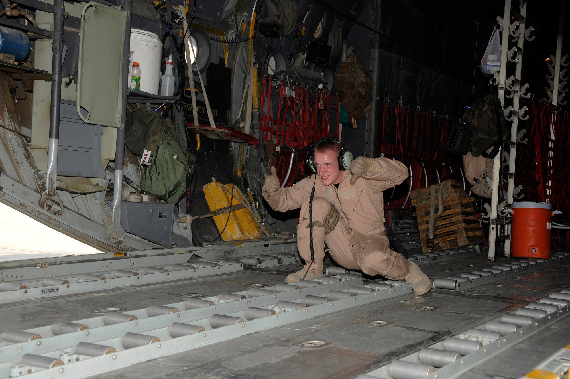 Airman 1st Class David Smallsreed, 746th Expeditionary Airlift Squadron, only appears to be giving contradictory hand signals to a 60K loader operator Aug. 28, 2008. The 60K loader is a versatile machine that can raise or lower front to back or side to side, to match other loading platforms. The C-130 Hercules it is matching took on two pallets of equipment and supplies to be transported further into the theater of operations supporting Operations Iraqi and Enduring Freedom and Joint Task Force-Horn of Africa.  Airman Smallsreed hails from Braceville, Ohio, and is deployed to this undisclosed location in Southwest Asia, from Yokota Air Base, Japan.  (U.S. Air Force photo by Tech. Sgt. Michael Boquette/Released)