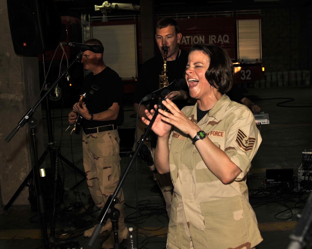8/30/2008 ? BAGHDAD INTERNATIONAL AIRPORT, Iraq - Tech. Sgt. Kim Lively, vocalist for the Air Force Central Command band ?Mirage,? captivates an audience of Iraqi firefighters as she sings a medley of Motown hits in what is most likely the first-ever performance of an American military rock band at Baghdad International Airport. (U.S. Air Force Photo by Master Sgt. Brian Davidson)