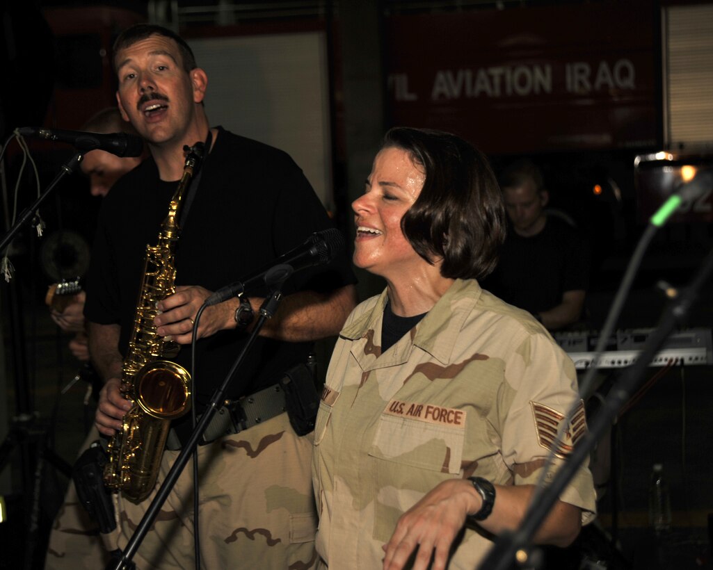 8/30/2008 ? BAGHDAD INTERNATIONAL AIRPORT, Iraq - Tech. Sgt. Kim Lively and Master Sgt. Mark Stanaford perform for an audience of Iraqi firefighters in what is most likely the first-ever performance of an American military rock band at Baghdad International Airport. Sergeant Stanaford is the band NCO in charge and saxophone player and Sergeant Lively is the vocalist for the Air Force Central Command band ?Mirage.? (U.S. Air Force Photo by Master Sgt. Brian Davidson)