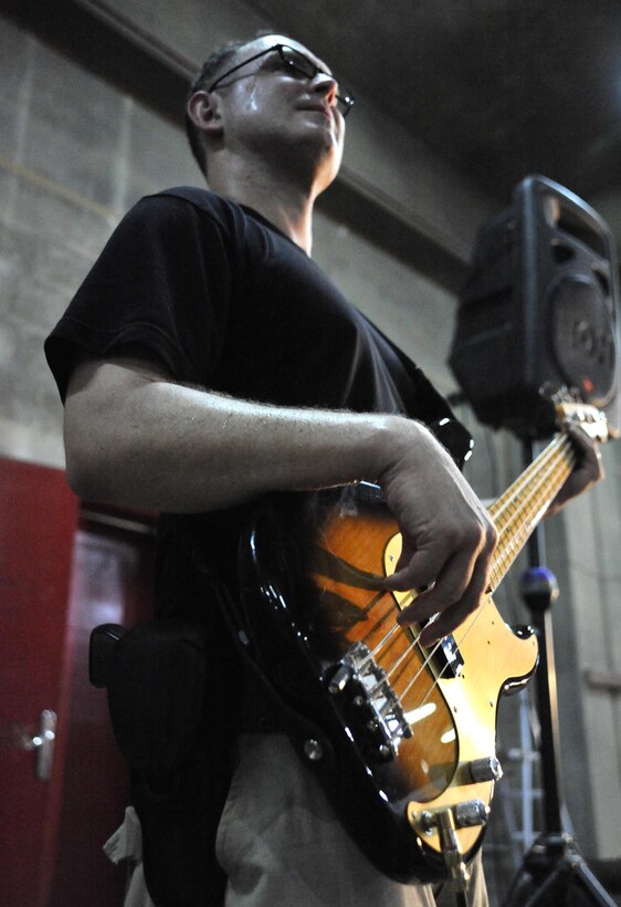 8/30/2008 ? BAGHDAD INTERNATIONAL AIRPORT, Iraq ? Tech. Sgt. Kenny Maurais lay?s down the bass while performing for an audience of Iraqi firefighters in what is most likely the first-ever performance of an American military rock band at Baghdad International Airport. Sergeant Maurais is both a base guitarist and music director for the Air Force Central Command band ?Mirage.? (U.S. Air Force Photo by Master Sgt. Brian Davidson)