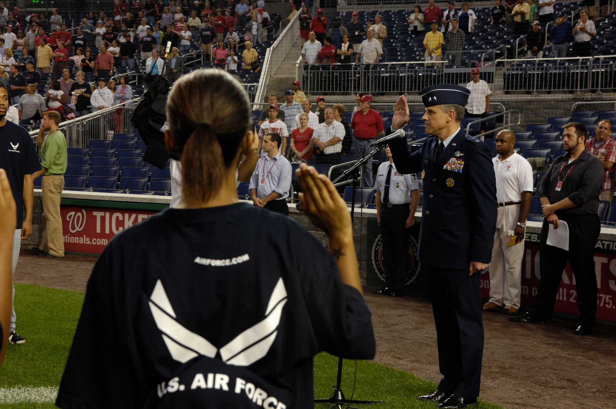 Maj. Gen. William Chambers, director of communication for the office of the secretary of the Air Force, administers the oath of enlistment to Air Force recruits during the Washington Nationals Air Force Appreciation Night held Aug. 29 at Nationals Park in Washington, D.C. This was the first time the Washington Nationals Major League Baseball team held an event honoring the Air Force at the new park. (U.S. Air Force photo/Senior Airman Marleah Miller)