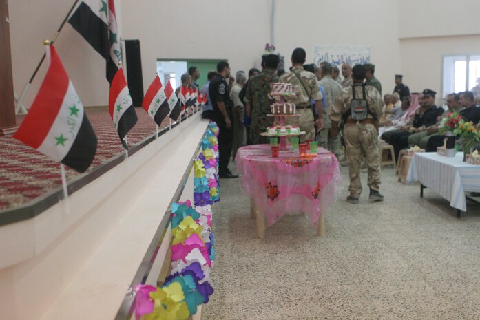 The stage of the new youth center in Anah, Iraq, is lined with flags of Iraq as members of the community gathered to celebrate the grand opening Aug. 30. The center had been previously used as a military outpost by Coalition forces. Since the demilitarization, Marines with Civil Affairs Team 5, Detachment 1, 2nd Battalion, 11th Marine Regiment, Regimental Combat Team 5 and the embedded Provincial Reconstruction Team have worked with local contractors to renovate the building to be used by the people of Anah.