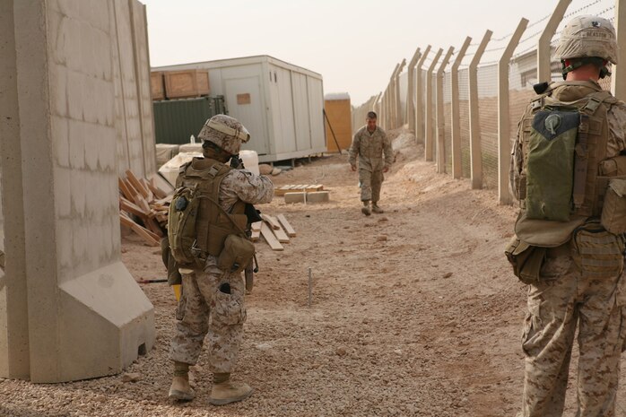 Cpl. Hue Moua, left, a administrative clerk with Headquarters Company, Regimental Combat Team 5, and Cpl. Charlie Beaston, a mortarman assigned to mobile assault platoon, RCT-5, practice prisoner detention techniques Sept. 3 behind the gymnasium aboard Camp Ripper.  The Marines are part of Provincial Rifle Platoon 3 and were participating in training for the platoon.  Beaston is one of 14 infantry Marines assigned to PRP-3, but Moua and about 30 other Marines in the platoon come from a variety of non-infantry military occupational specialties, and the training was meant as a way of developing unit cohesion and reinforcing basic rifleman skills that may have become rusty since Marine Combat Training.