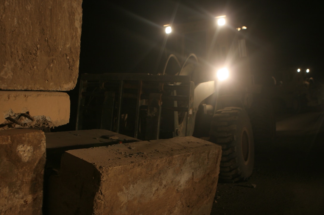 RAMADI, Iraq (August 29, 2008) – Marines with Combat Logistics Company 51, Combat Logistics Battalion 5, 1st Marine Logistics Group, use a Tractor, Rubber tired, Articulate steering, Multi-purpose vehicle to pick up “Texas” barriers at Combat Outpost Jumayiah so they can be transported to al-Sora. Service members worked from the COPs to provide additional safety and support for the Iraqi people. The platoon sized bases were being demilitarized and consolidated with the larger bases outside the cities in order to transfer security of al-Anbar Province to the Iraqi Civilian Authority and the Iraqi Security Forces. (Photo by Lance Cpl. Jacob A. Singsank)