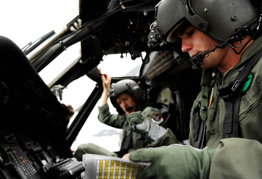 MOODY AIR FORCE BASE, Ga. --  1st. Lt. Sean Ruane, 41st Rescue Squadron HH-60G Pave Hawk co-pilot, and Capt. Adam Rudolphi, 41st RQS HH-60G command pilot, perform a pre-deployment inspection on a 41st RQS aircraft here Aug. 31. The 41st RQS is preparing to enter storm ravaged areas of the Gulf Coast with other rescue and support units of Moody's 23rd Wing as part of the national response framework for Hurricane Gustav. (U.S. Air Force photo by Tech. Sgt. Parker Gyokeres)